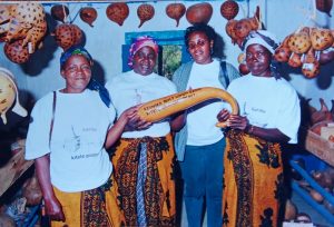 Kyanika Adult Women Group pose with their mascot in Kitui