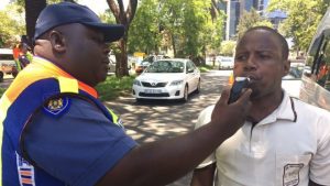 South African Police test a driver for drink driving. A BBC pic.