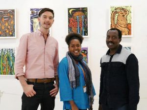 Art Curator Lydia Gatundu-Galavu flanked by Artists Clinton Kirkpatrick (left) and John 'Silver' Kimani (right) during the opening of the Life and Other Fictions exhibition at Nairbi National Museum on July 5, 2018.